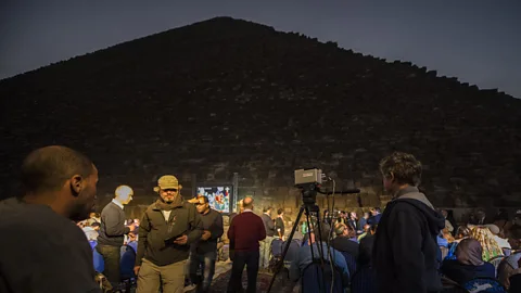 Getty Images Researchers wait next to the great pyramids of Giza during an infrared thermography experiment to map the thermal footprint of the walls (Credit: Getty Images)