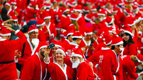 Phil Walter/Getty Participants of the Great Kids Can Santa Run in New Zealand dress up as Santa Claus to benefit children affected by poverty (Credit: Phil Walter/Getty)