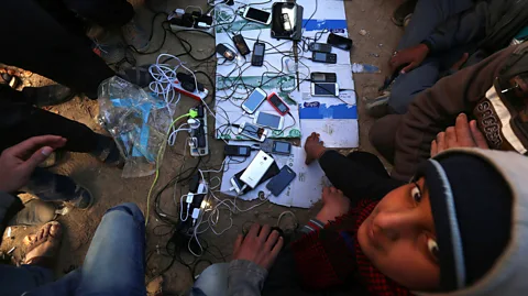 Safin Hamed/AFP/Getty Images Displaced Iraqis, who fled violence in Mosul, charge their mobile phones (Credit: Safin Hamed/AFP/Getty Images)