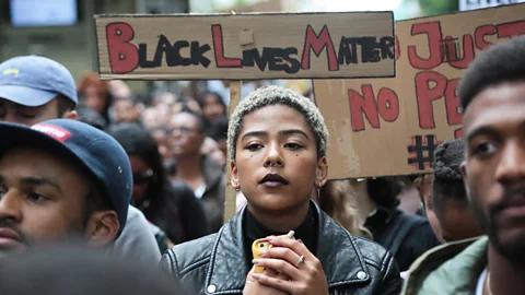 Alamy Many talk of the heavy burden of receiving a constant stream of negative messages and images associated with being black (Credit: Alamy)