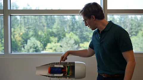 John Garay Wright Electric founder and CEO Jeff Engler shows a model of a motor for an electric plane (Credit: John Garay)