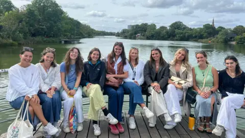 Jenny Thomas Lois Vidamour, Hannah Langlois, Emily Savident, Alex Oliver, Suzannah Tostevin, Sophie De La Mare, Orla Rabey, Abi Tardivel, Jenny Thomas and Hannah Vidamour (left to right) sat riverside in Copenhagen.