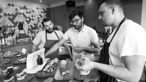 The Fish and The Chip Aatkin Anadkat (middle) tasting food at The Fish and The Chip