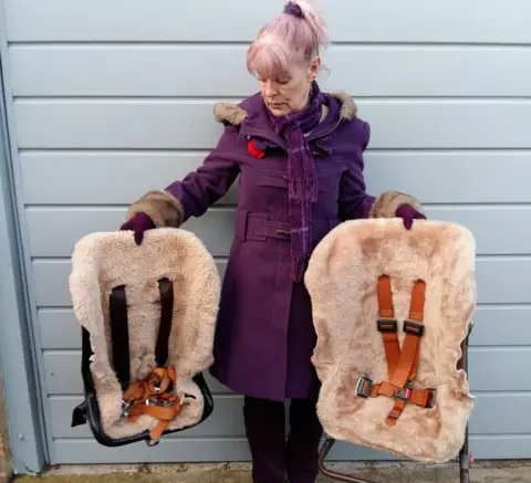 Mel Kirkpatrick Mel Kirkpatrick holding her children's old car seats