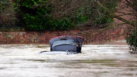 PA Media A vehicle is submerged under water near the River Devon, in Bottesford, Leicestershire.