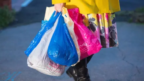 PA Media woman with carrier bags