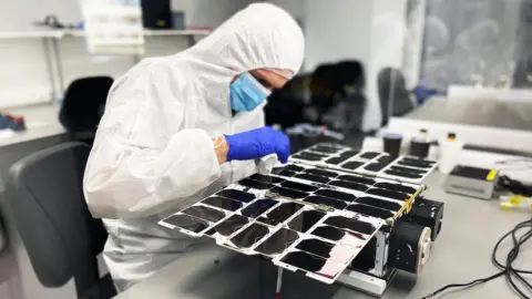 NanoAvionics A NanoAvionics engineer assembling a nanosatellite