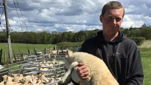 Rob Campbell farmer with sheep