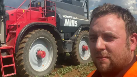 Nathan Parsons Man in front of tractor
