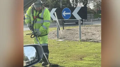 Nigel Castle The council worker strimming the plastic grass