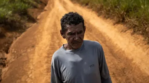 EPA Joao Batista Rodrigues Costa, 61, poses after having walked 20 days in the jungle on the banks of the Uraricoera river to get out of the Yanomami reserve, in Puerto del Arame, Villa de Paredao, in Alto Alegre, Brazil, 07 February 2023