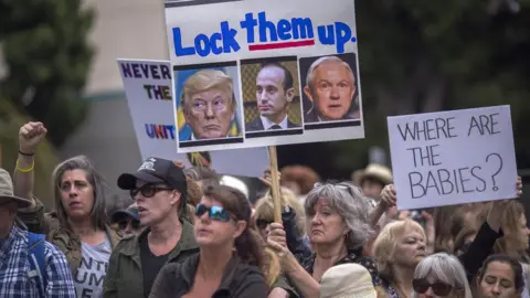 Getty Images Protesters demand children be reunited with their immigrant parents during a demonstration, June 23, 2018 in San Diego, California.