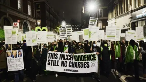 PA Media Survivors and bereaved families and friends protesting against the criminal investigation