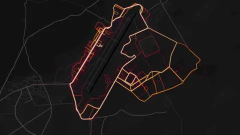 Strava Red "heat lines" are arrayed neatly in the pattern of roads and streets on a dark black map